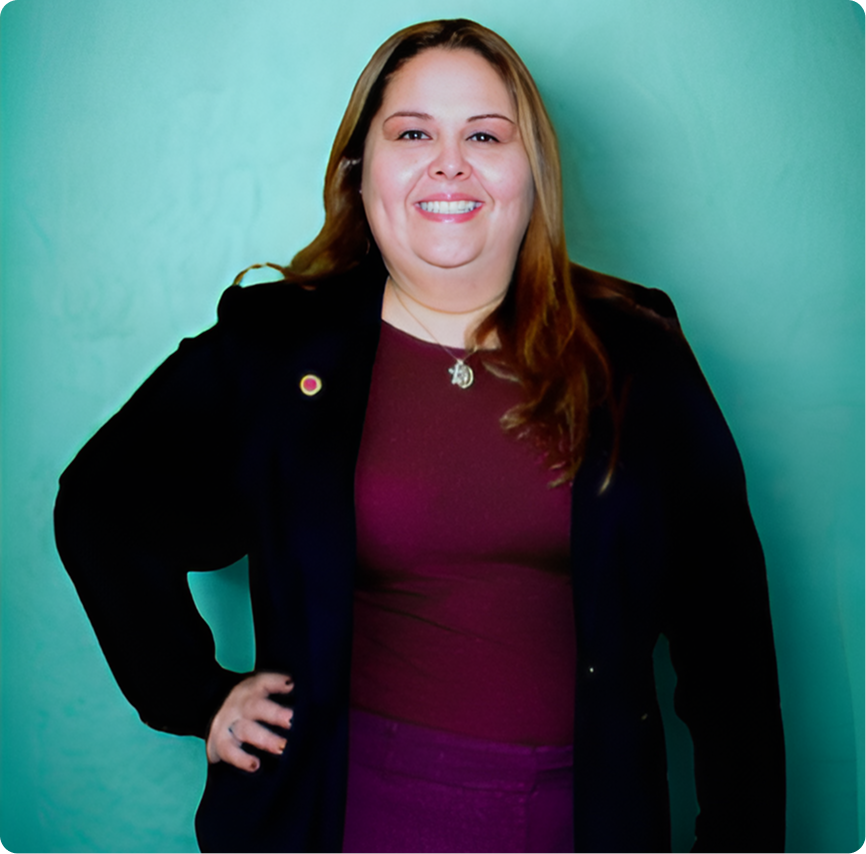 Smiling woman in blazer with hand on hip