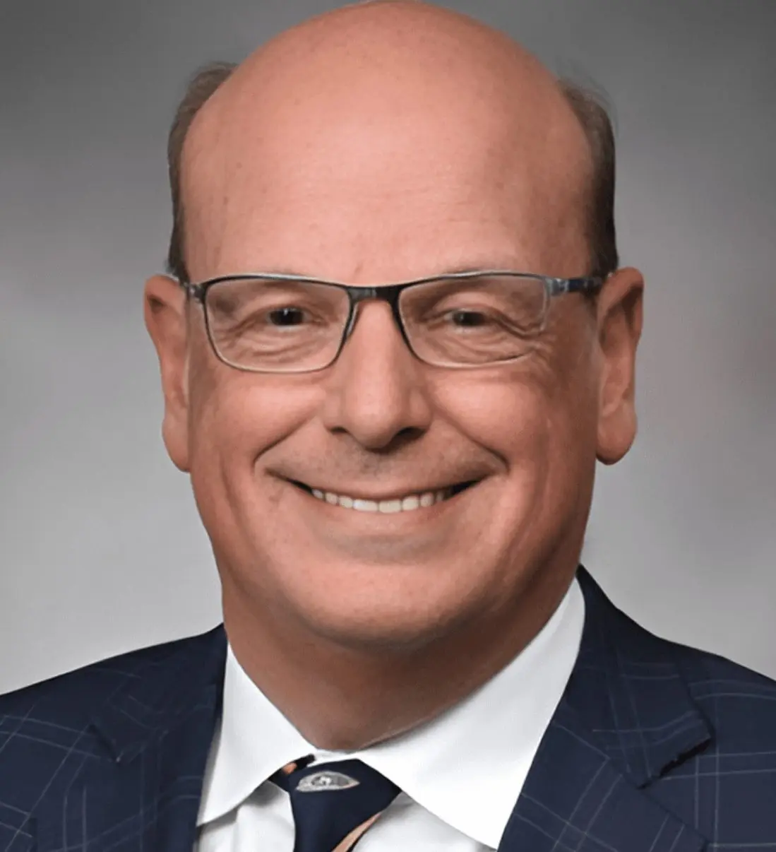 Smiling bald man with glasses in suit