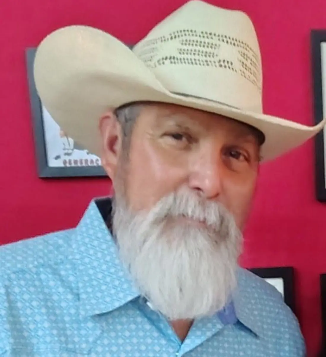Bearded man in cowboy hat and blue shirt