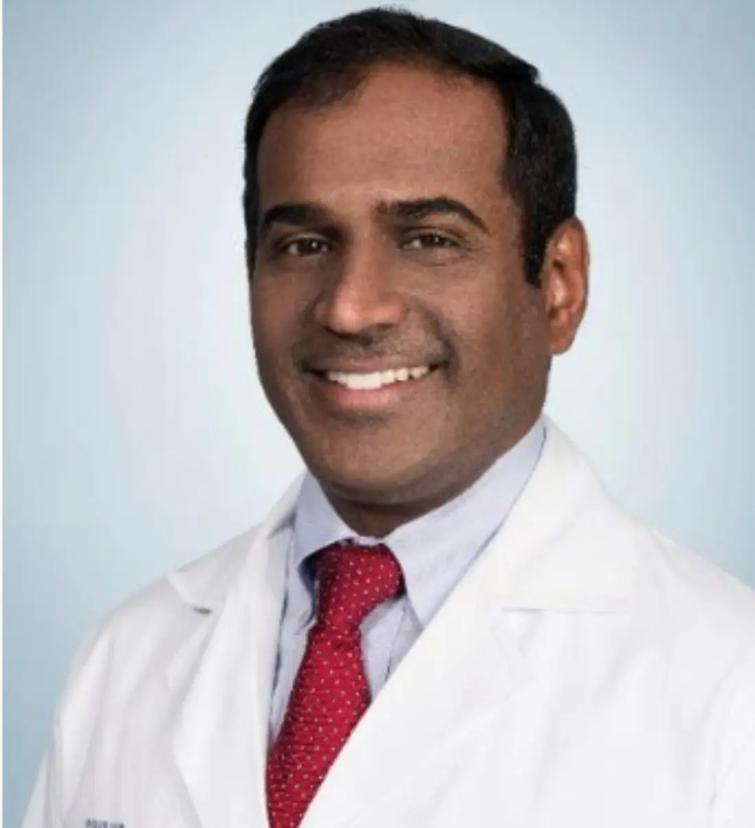 Smiling male doctor wearing white lab coat