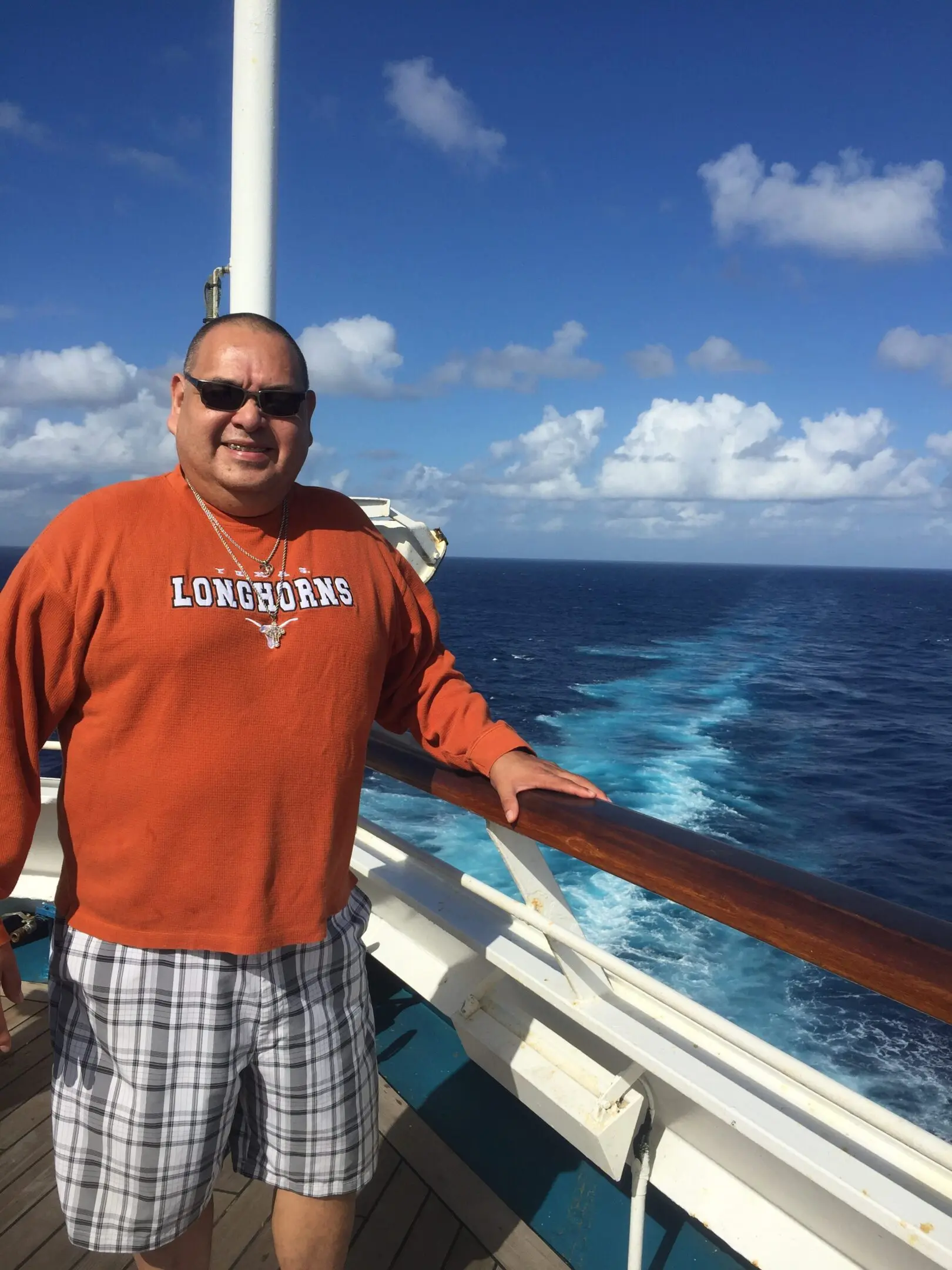 Man in orange Longhorns shirt on cruise ship