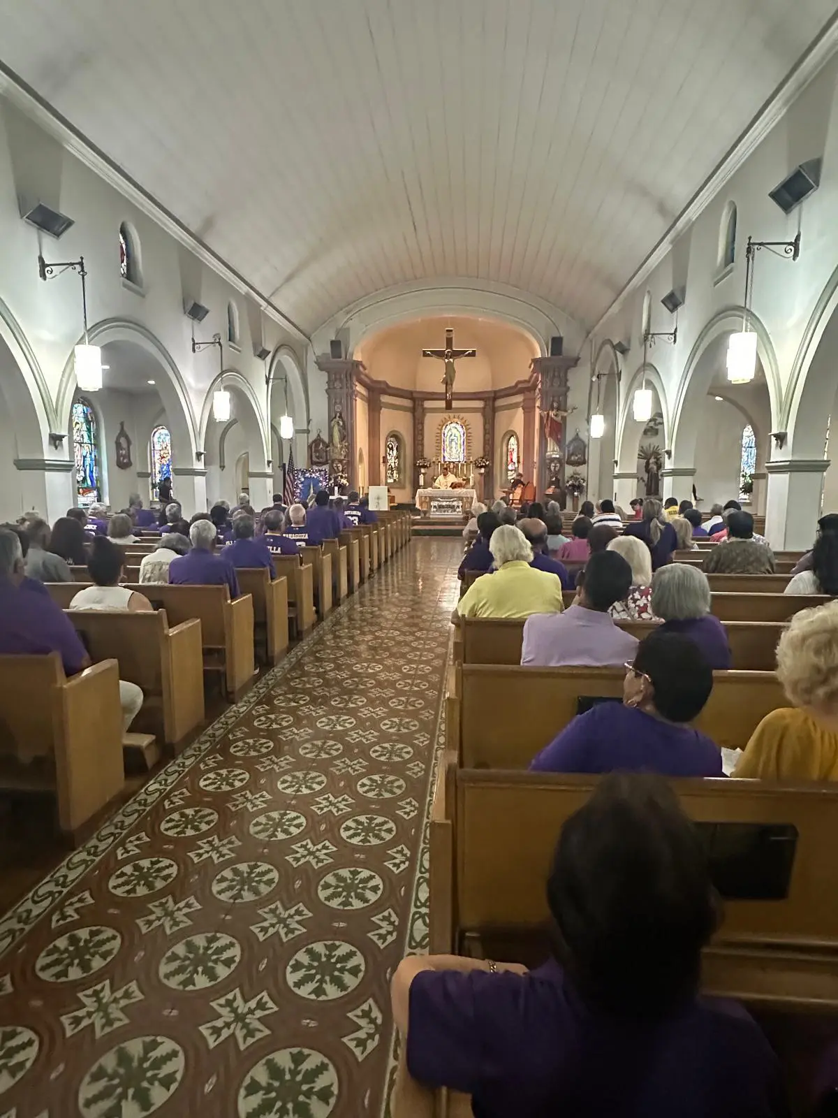 Congregation seated in church facing the altar
